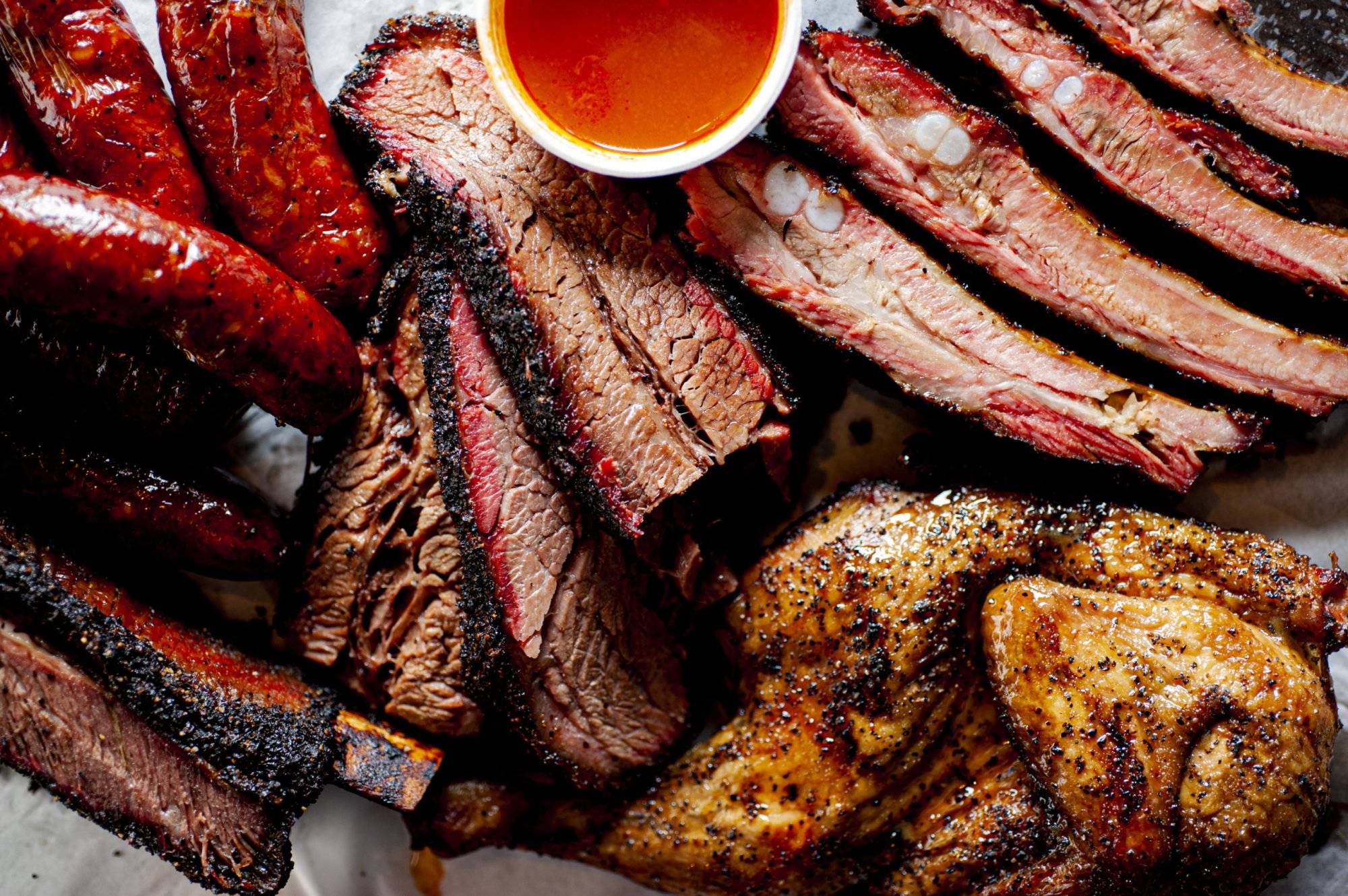 Barbecue. Barbecue table spread. Beef brisket, chicken, pork ribs, beef ribs, Mac n cheese, cornbread, Brussels sprouts, coleslaw & beer. Classic traditional Texas meats & side dishes. Barbecue. Barbecue table spread. Beef brisket, chicken, pork ribs, beef ribs, Mac n cheese, cornbread, Brussels sprouts, coleslaw & beer. Classic traditional Texas meats & side dishes.