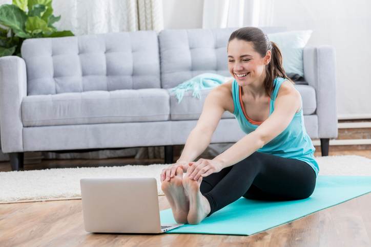 Healthy woman watches exercise video Healthy woman watches exercise video