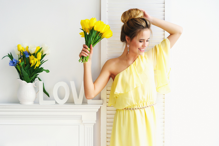 Gorgeous young woman with yellow tulips
